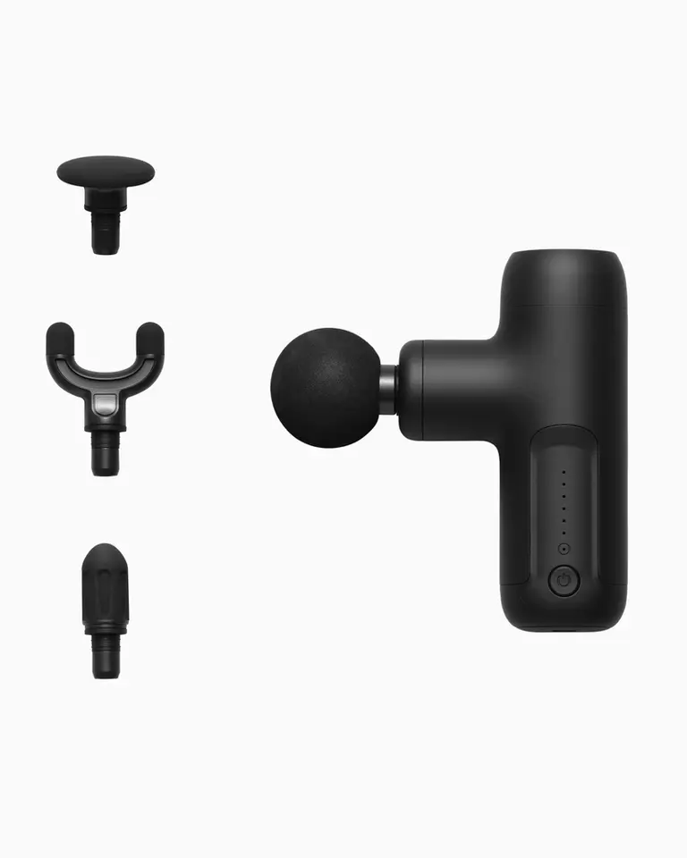 Matte black Flowgun Air shown in side profile with four interchangeable heads for versatile percussive therapy.
