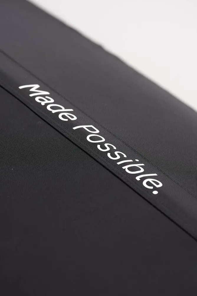 Close-up of the black Flowchamber Oxygen Elite 170 Soft-Shell fabric featuring white "Made Possible." branding.