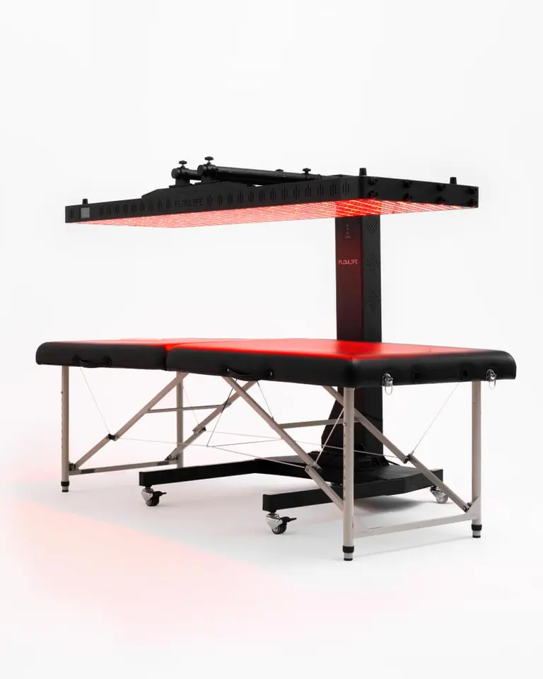 Flowlight Auto Static Stand with a horizontal red light therapy panel positioned above a black treatment table.