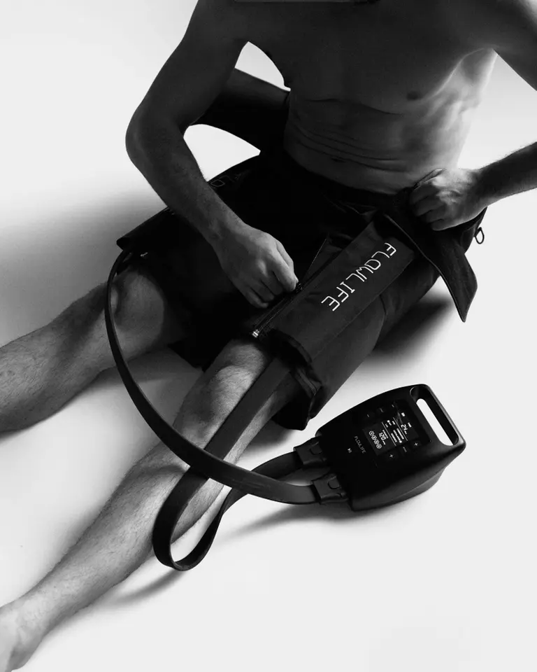 Black Flowpression Hip Attachment worn for targeted hip and groin compression therapy with the Pro+ control unit.