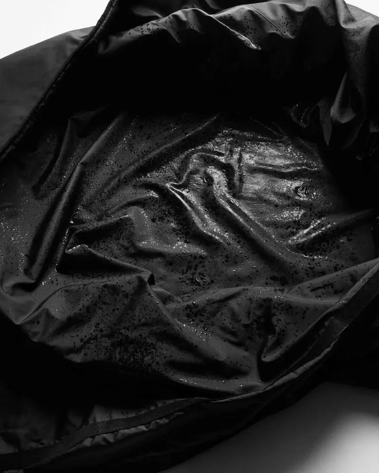 Waterproof black PU leather interior of the Flowsauna Blanket Pro with sweat-resistant texture and moisture droplets.