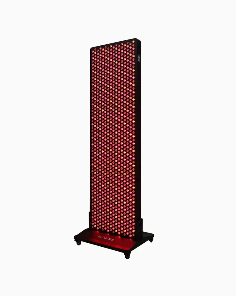 Flowlight 4300 Eight Waves full-body red light therapy panel on a black wheeled stand with glowing LEDs.