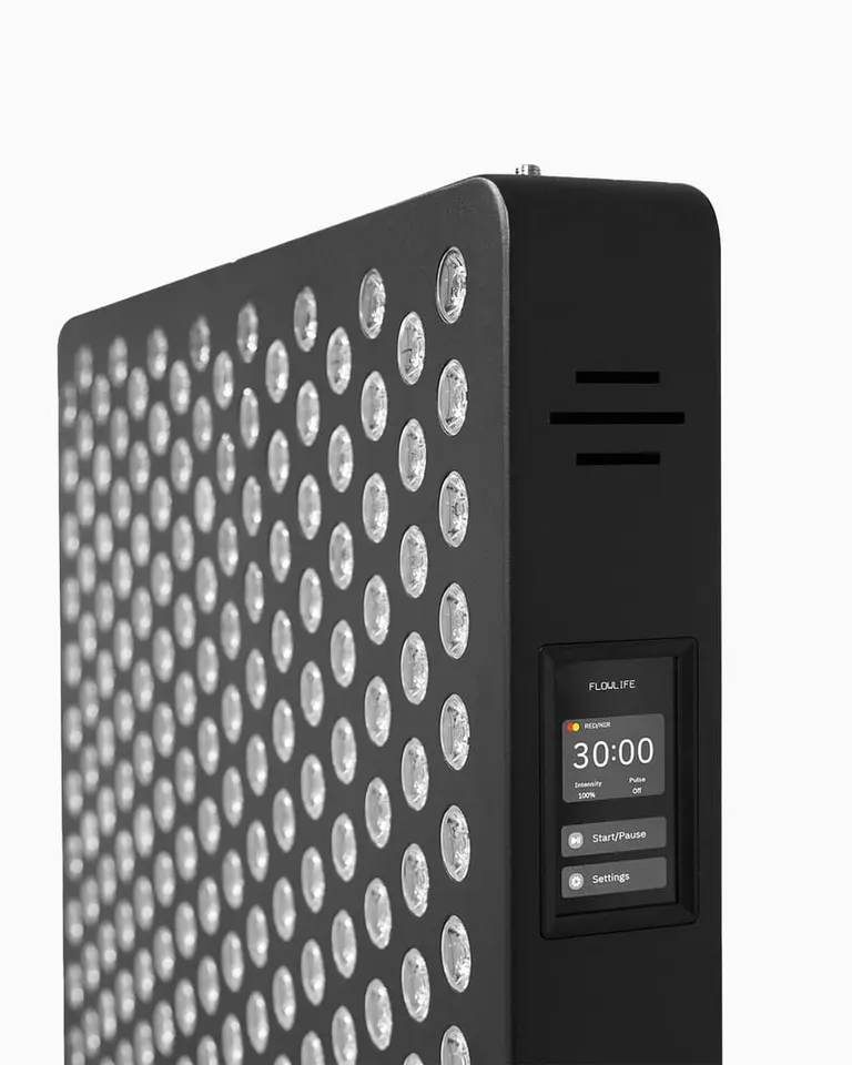 Side-angle view of the black Flowlight 4300 Eight Waves red light therapy panel, featuring a digital control screen.