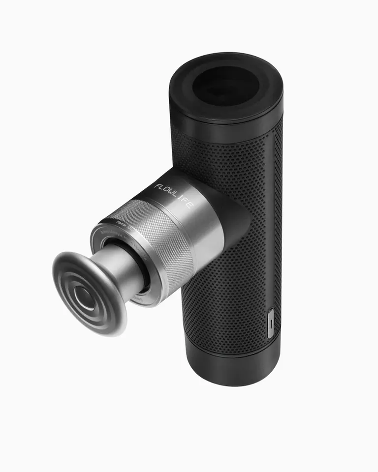 Flowgun ONE percussive therapy device with a black textured aluminum body and a silver metal massage head.